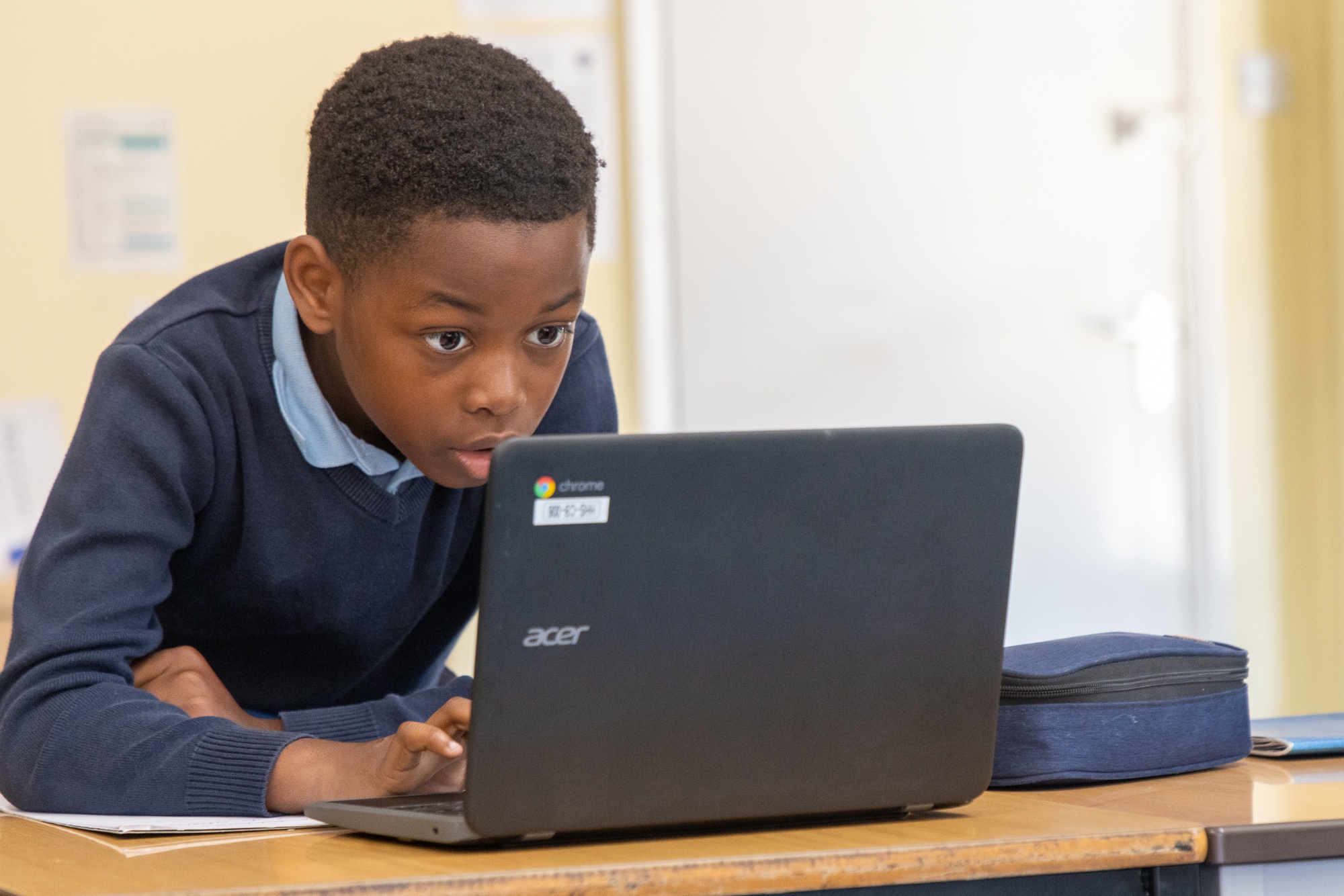 A child looking at the laptop computer