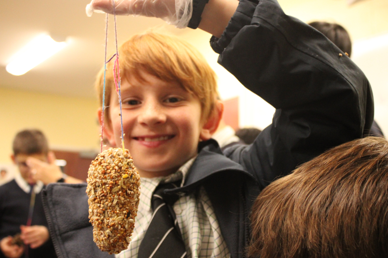 A Horris Hill Year 8 student holding a hand made bird feeder