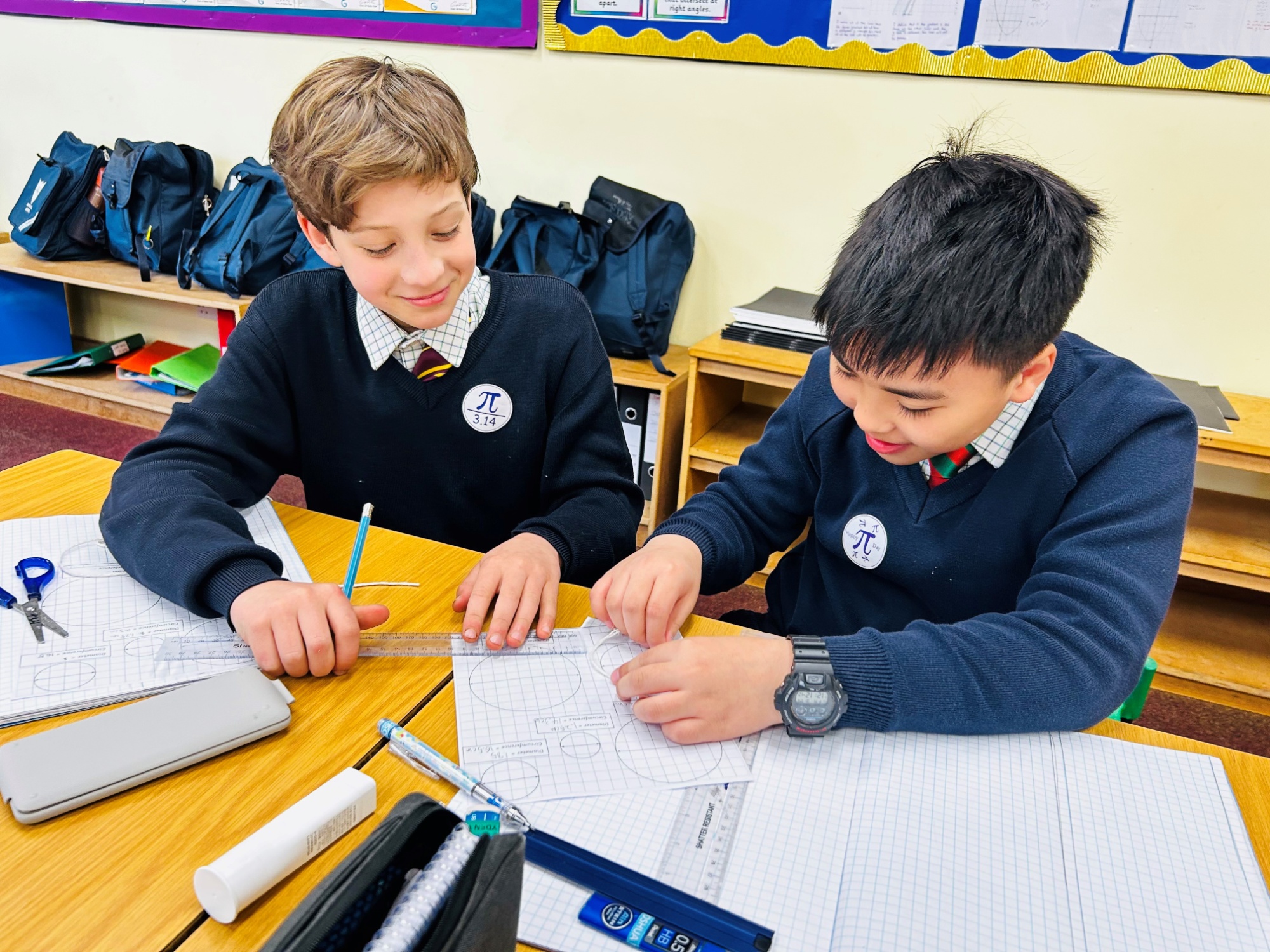 Two Horris Hill pupils work on maths problems in the classroom