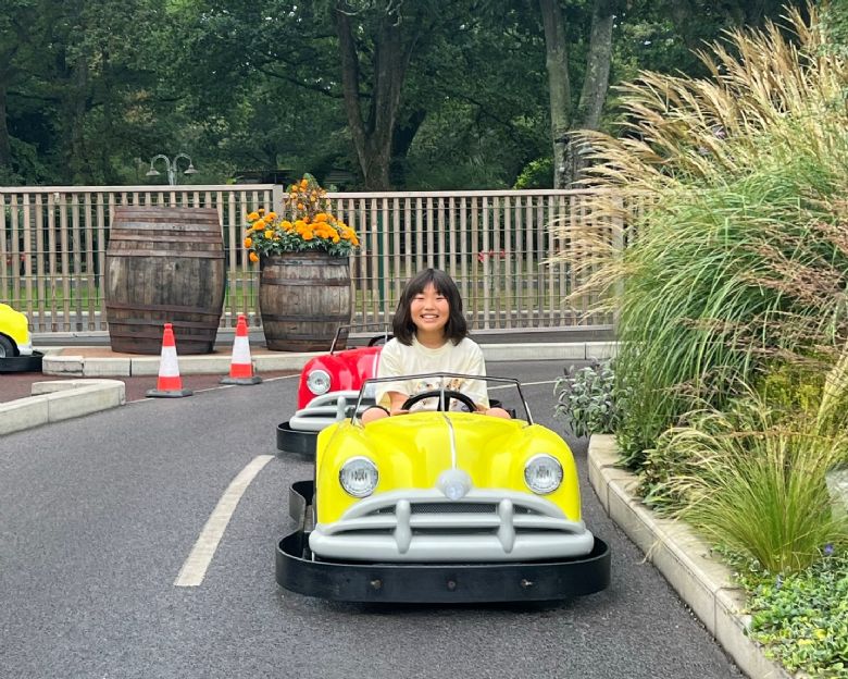 A Horris Hill boardin student enjoying a car racing ride at Paulton's Park